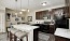 Kitchen with island, brown cabinets, and marble-style countertops