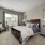 Apartment bedroom with furniture and large window