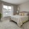 a bedroom with a bed and a plant